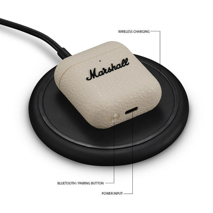 Marshall Minor IV True Wireless Earbuds, cream/ivory, charging case on wireless charging pad