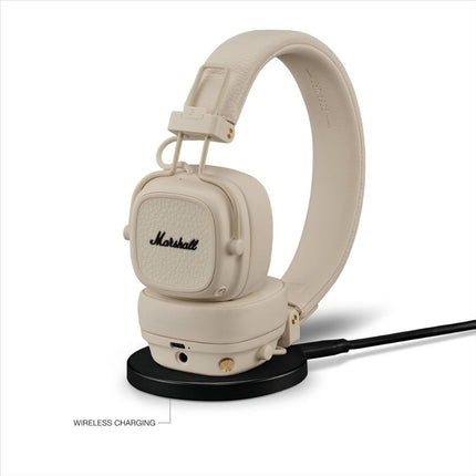 Marshall Major V Wireless On-Ear Headphones, cream/ivory, front view on wireless charging stand