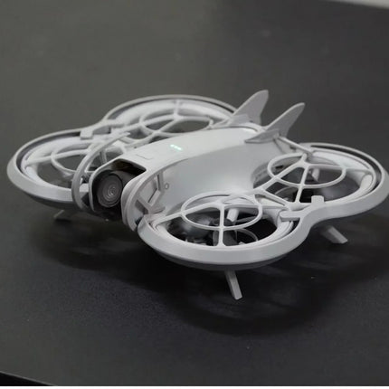 DJI Neo Drone, white/gray, top-down view on dark surface