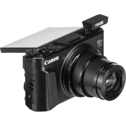 Canon PowerShot SX740 HS, black, front angled view with lens extended and screen partially raised