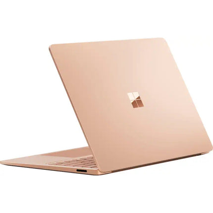 Microsoft Surface Laptop 7, sandstone gold, closed lid rear angled view