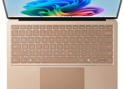 Microsoft Surface Laptop 7, sandstone gold, open top-down keyboard view