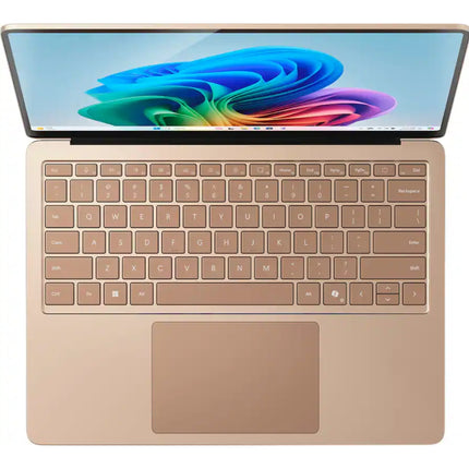Microsoft Surface Laptop 7, sandstone gold, open top-down keyboard view