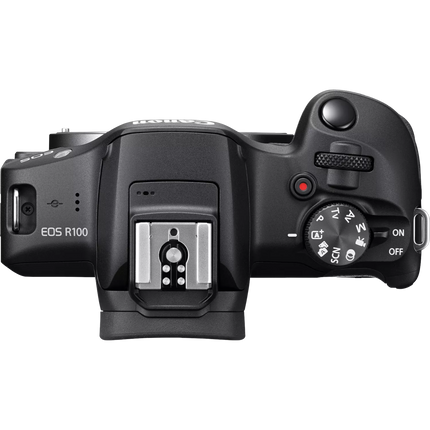 Canon EOS R100 Mirrorless Camera, black, top view showing dials and hot shoe