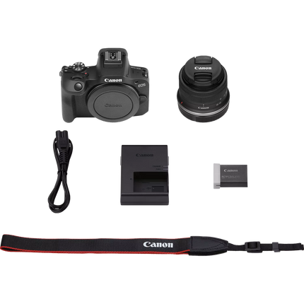 Canon EOS R100 Mirrorless Camera, black, box contents flat lay with accessories