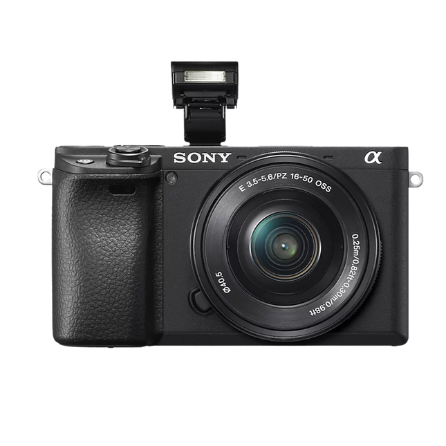 Sony Alpha 6400K, black, angled front view with flash raised and kit lens